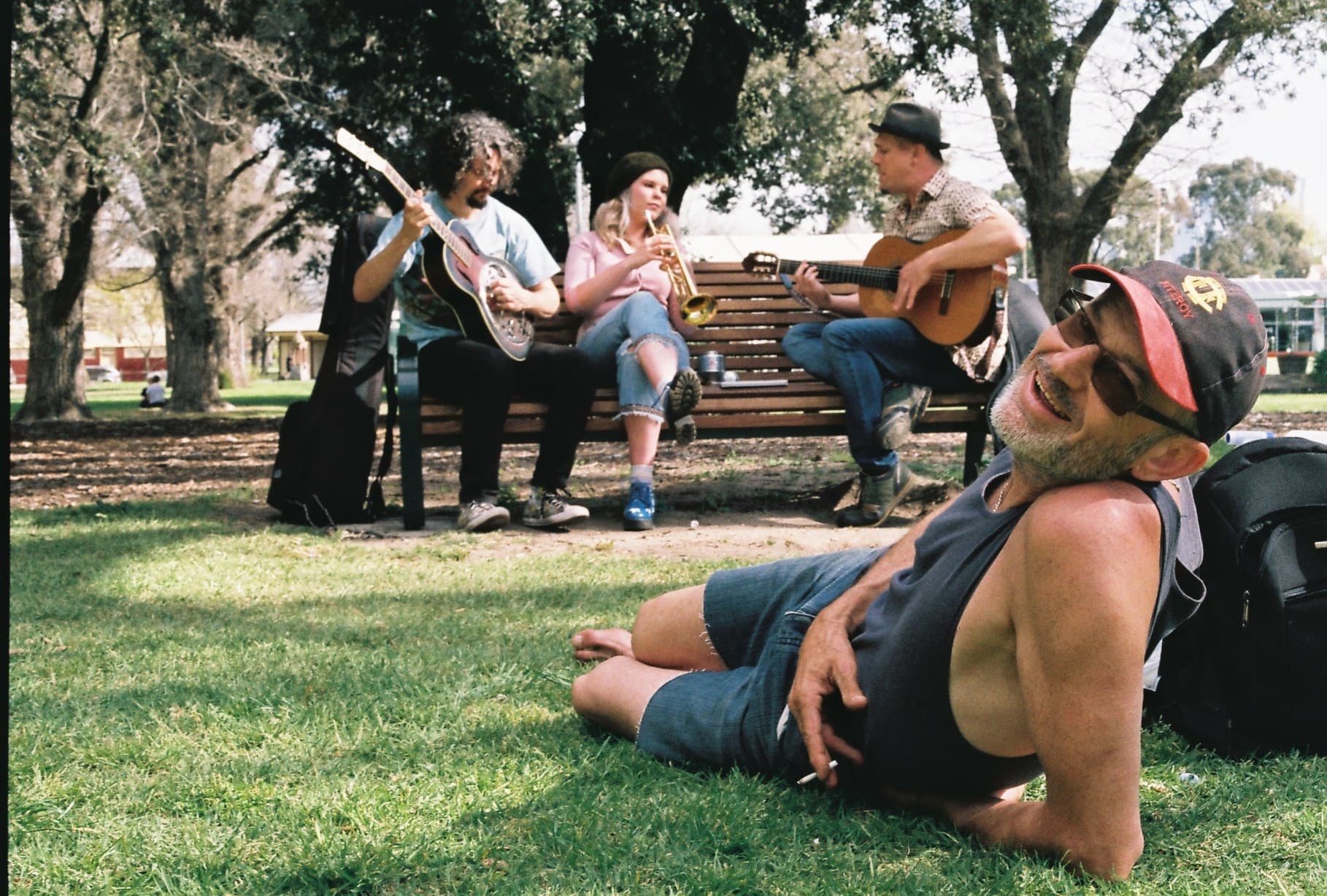 People relaxing on the grass in a park.