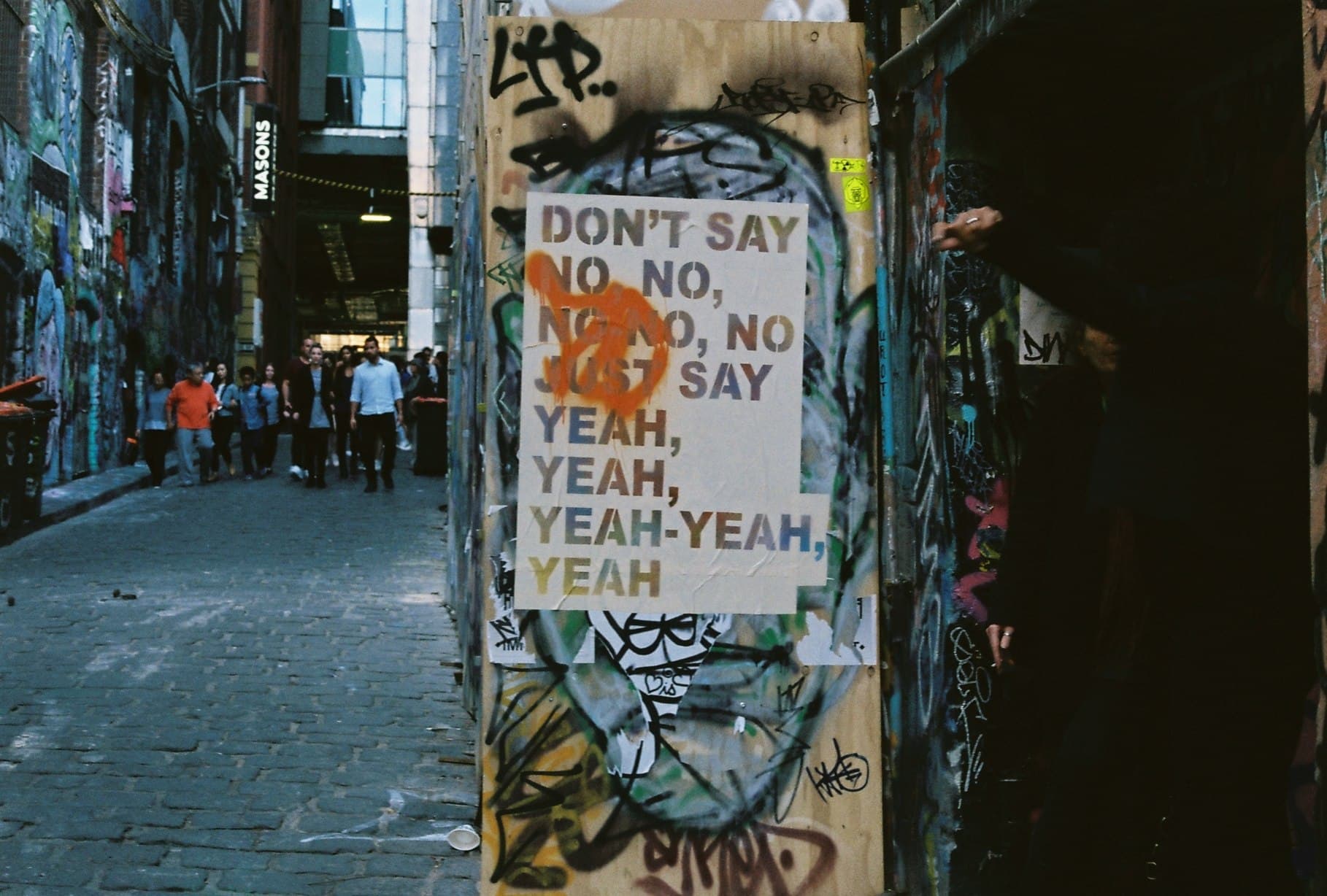 A printed sign fixed to a city street pole.