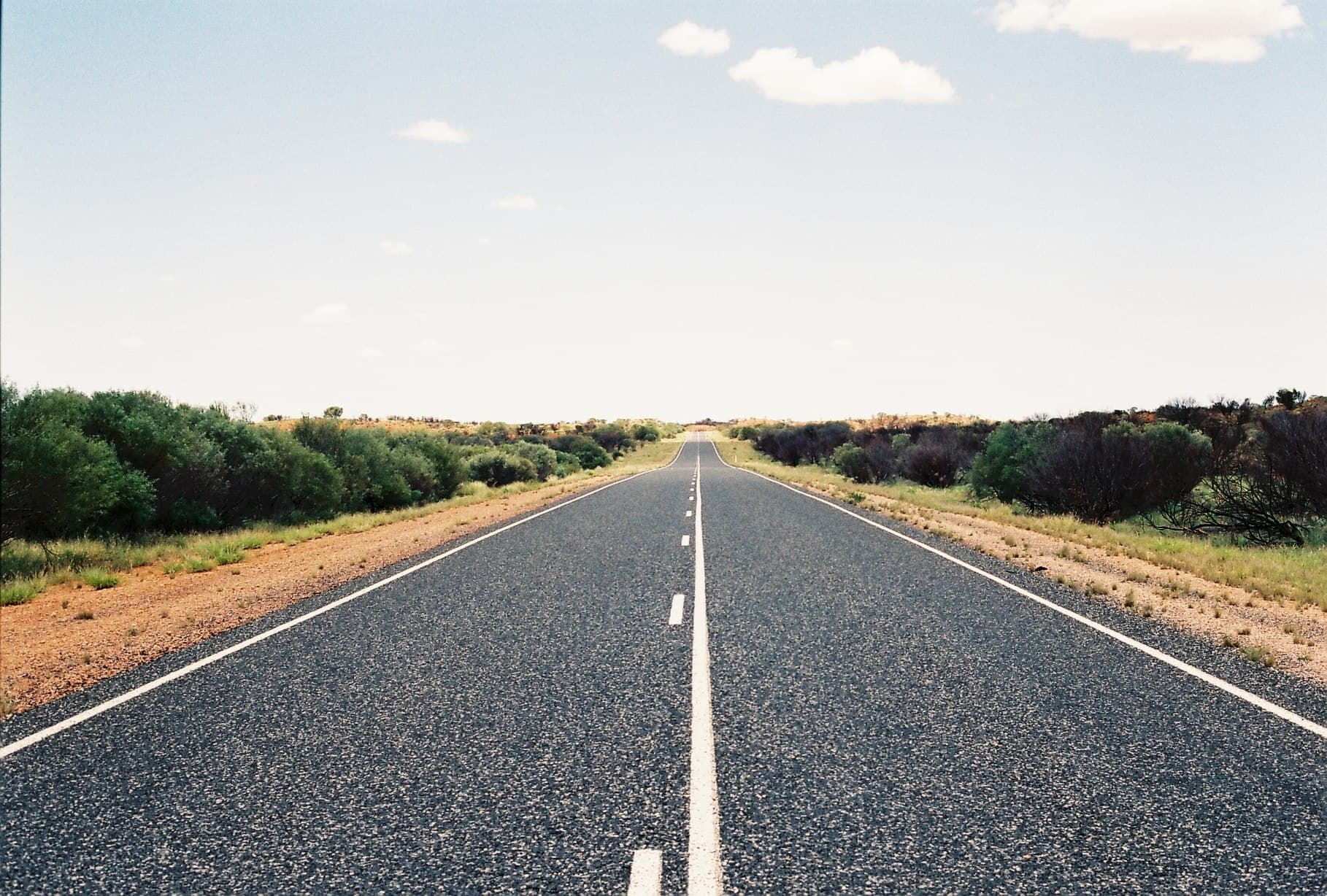 A long empty road running towards the horizon.