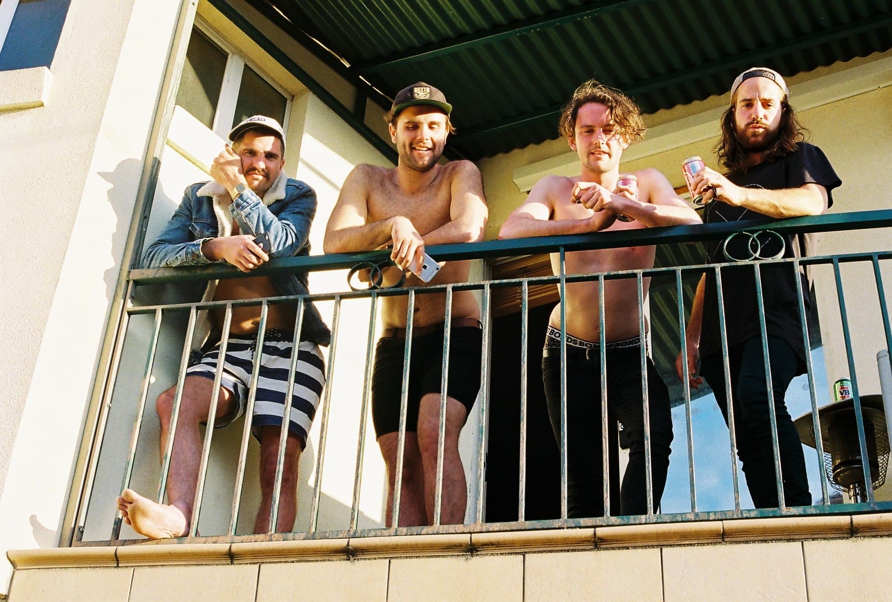 A group standing on an outdoor balcony.