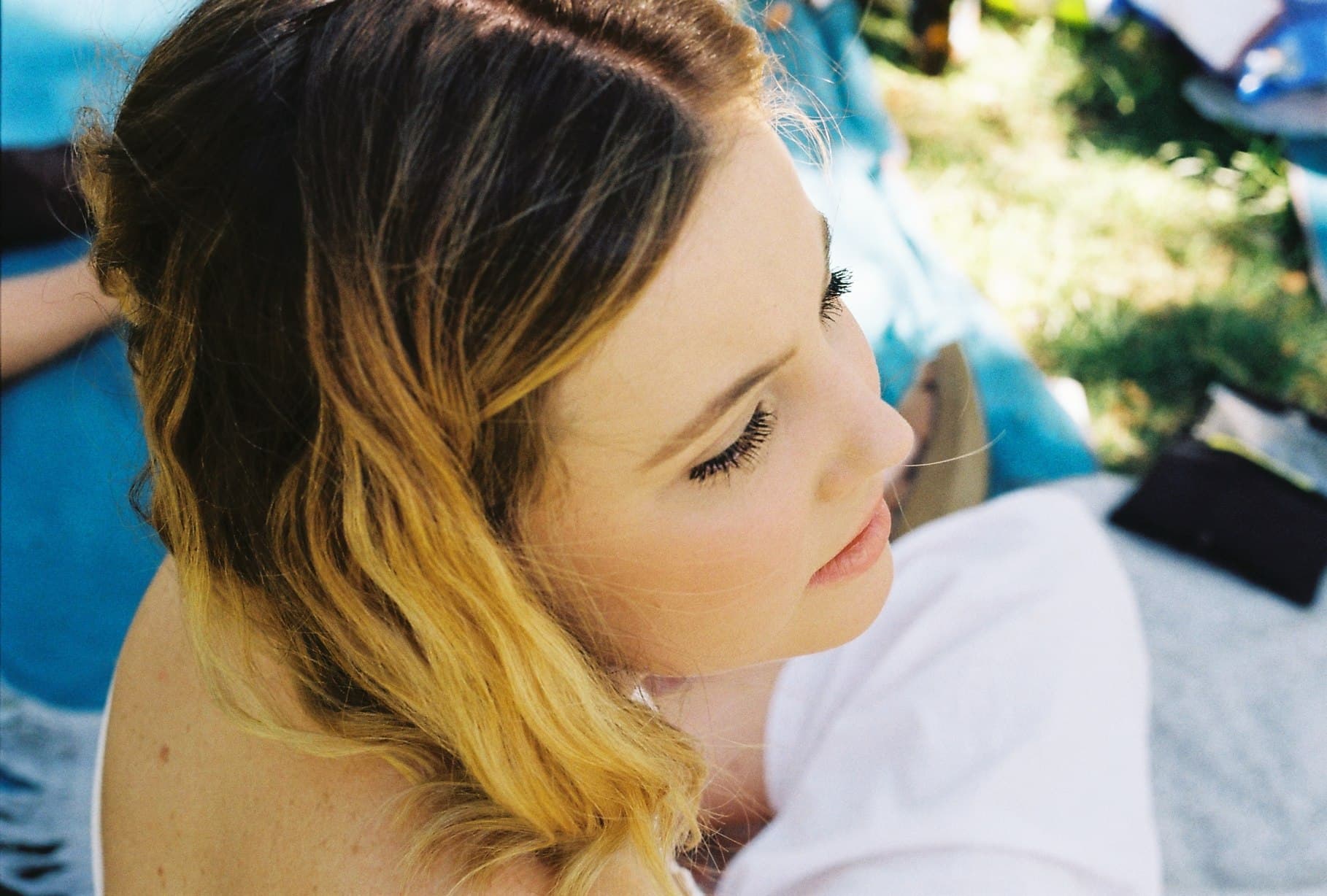 Close-up outdoor portrait with leafy shadows.