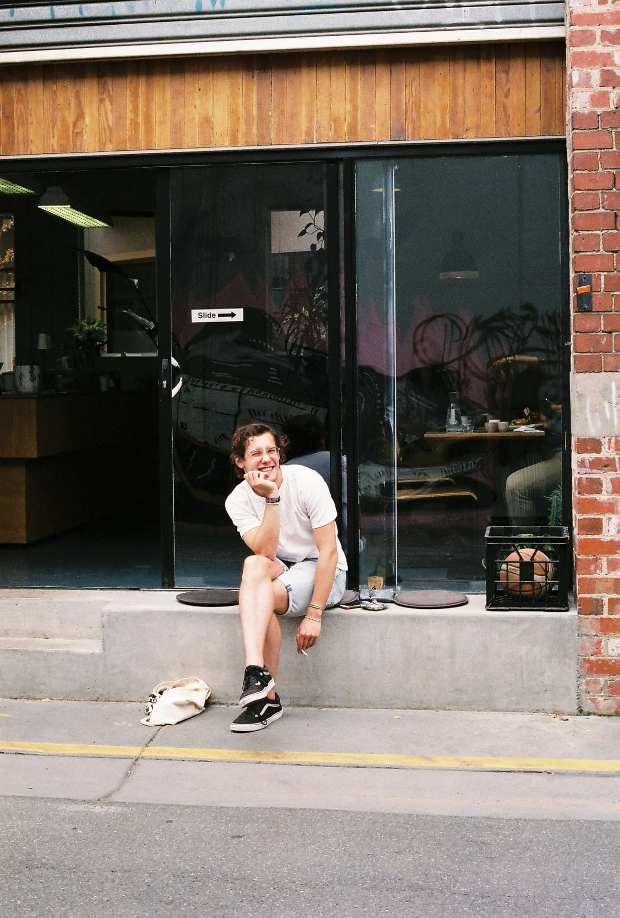 A person walking past a brick building on a city street.