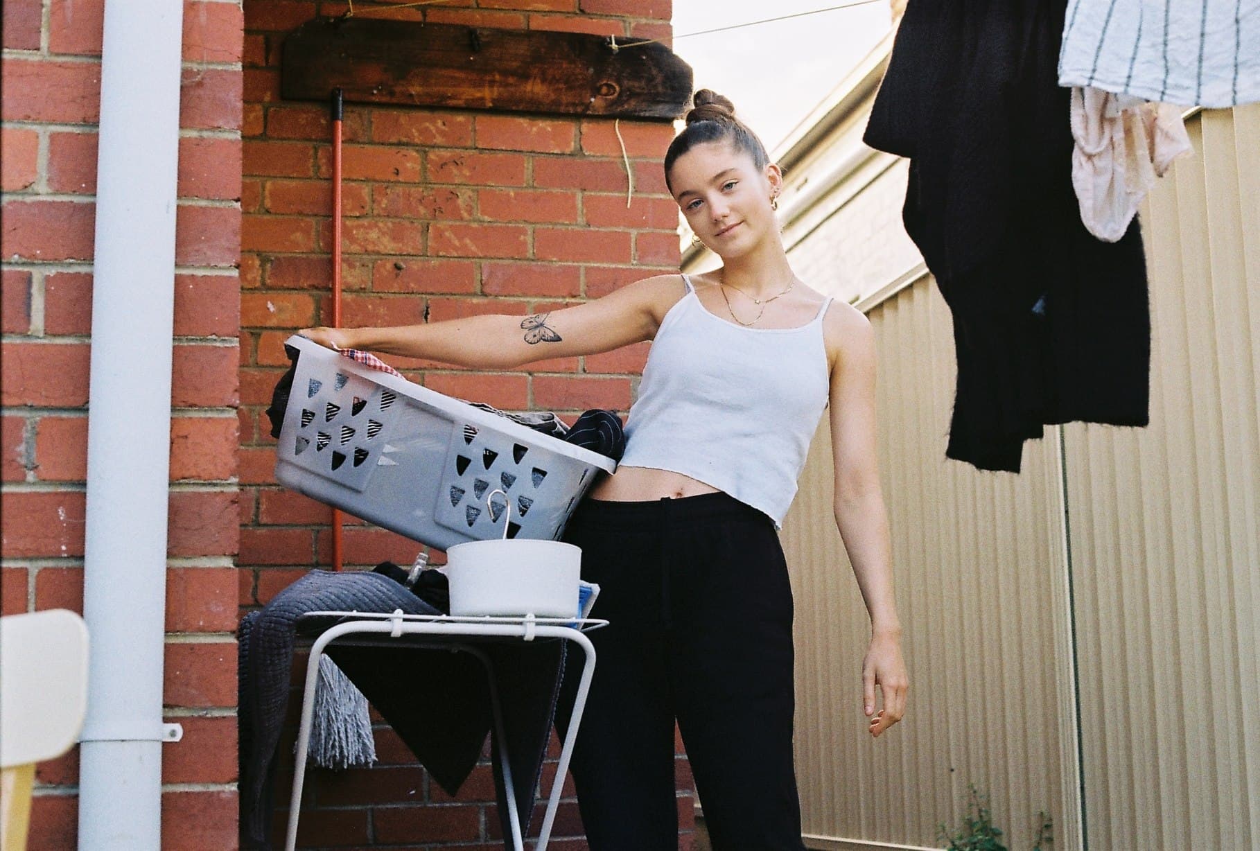 A person holding a printed sheet near a doorway.