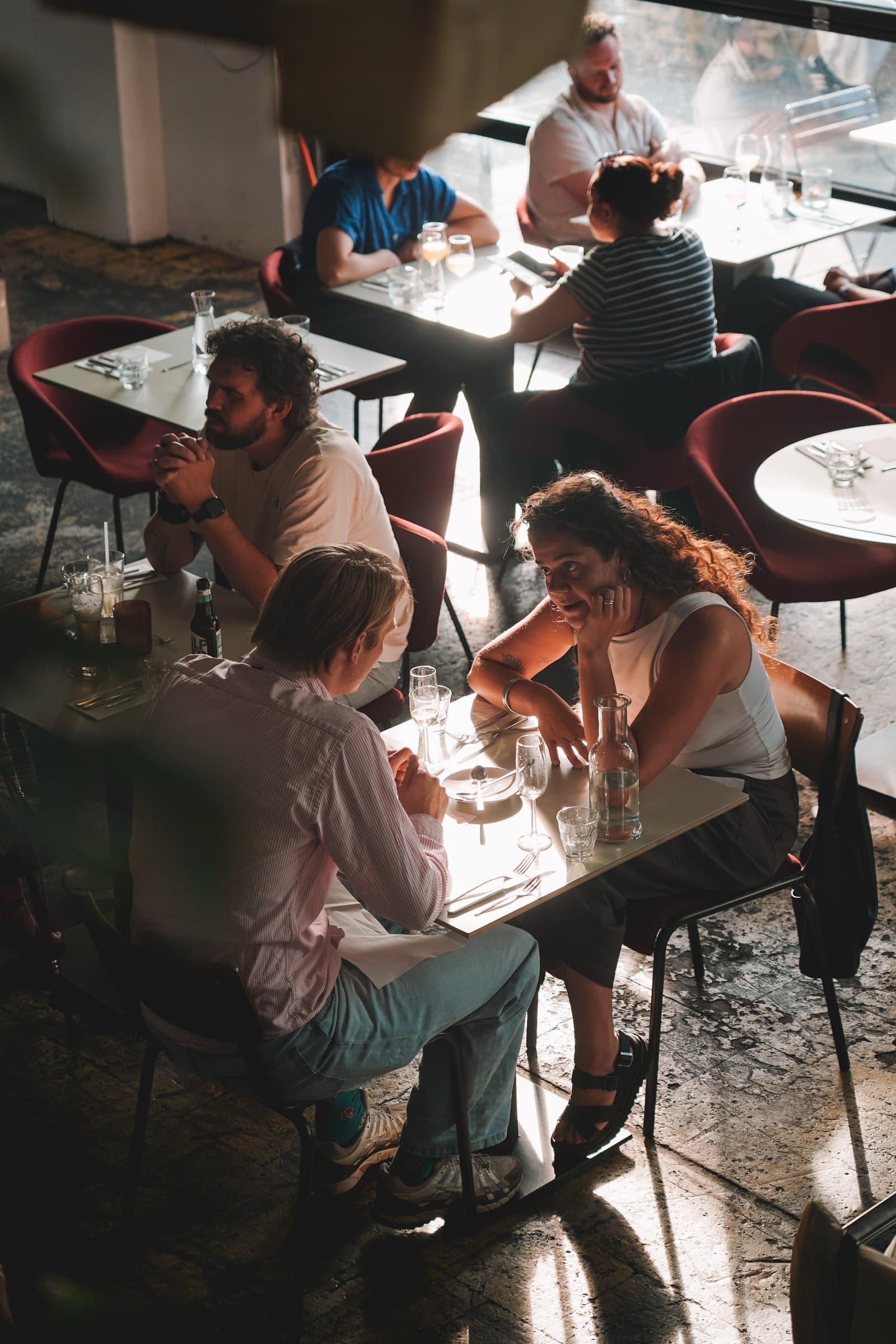 Guests enjoying dinner around tables, photographed from above.