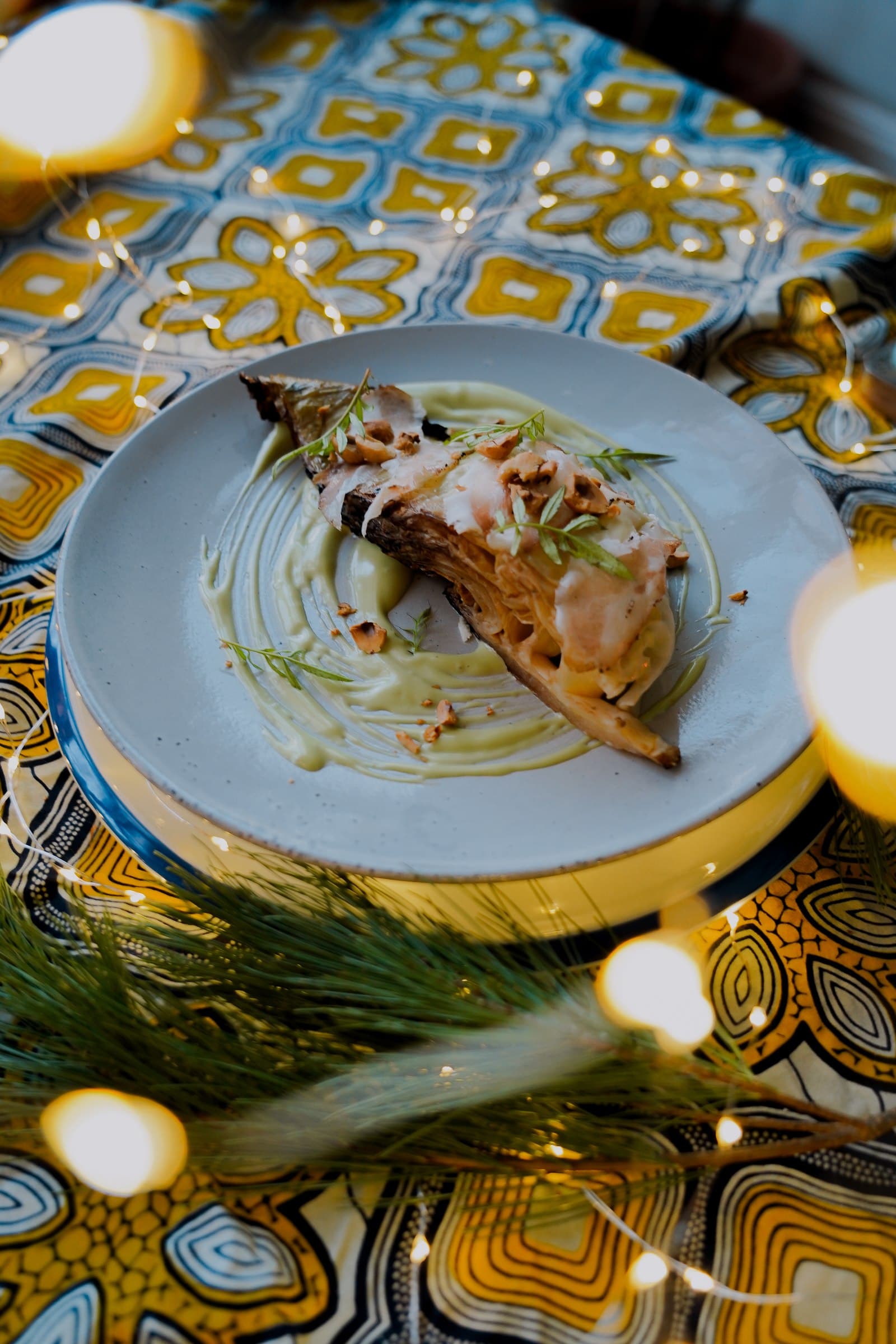 A plated dish on a colourful patterned tablecloth.