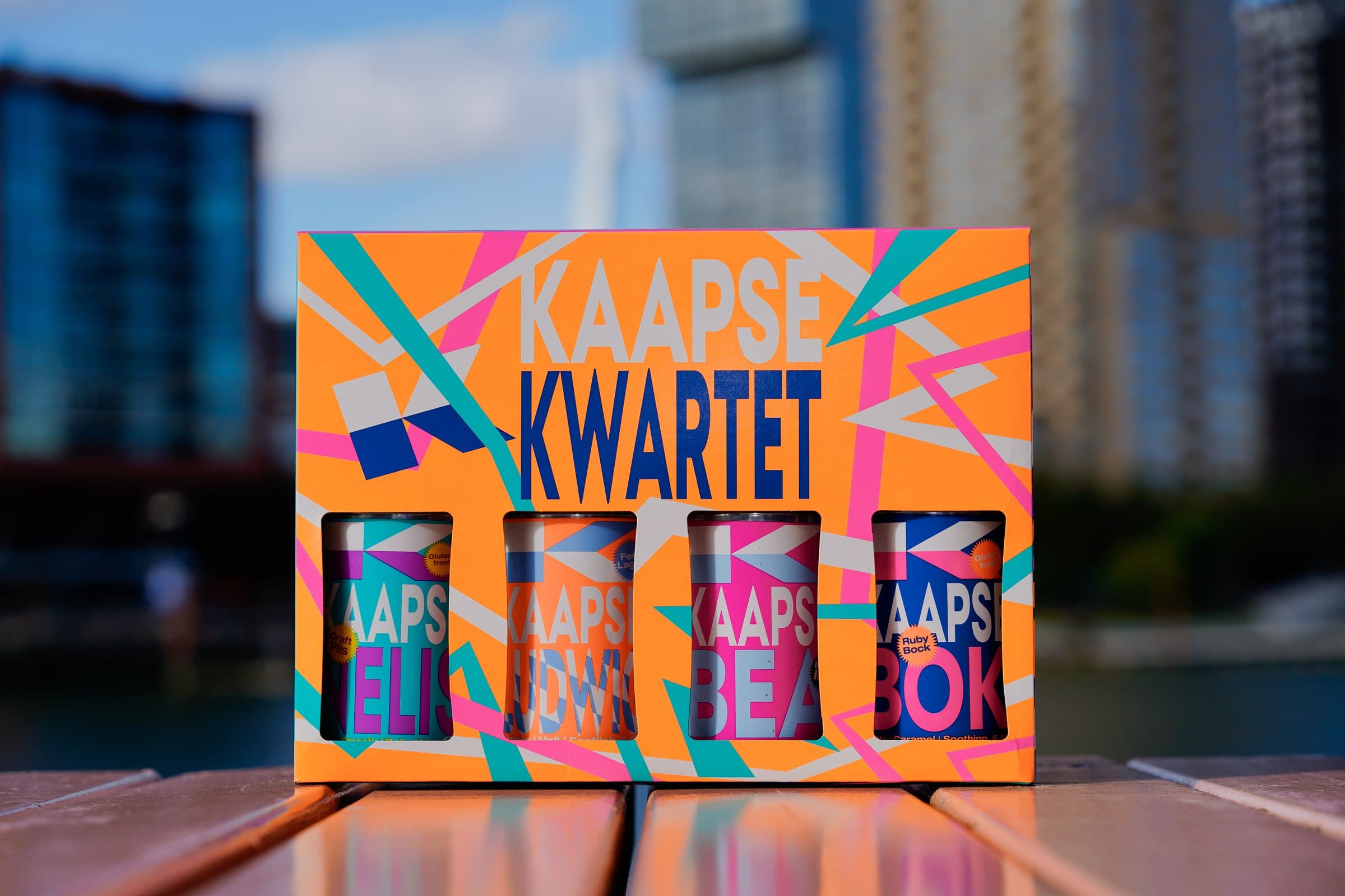 A colourful boxed selection of Kaapse beers photographed outdoors.