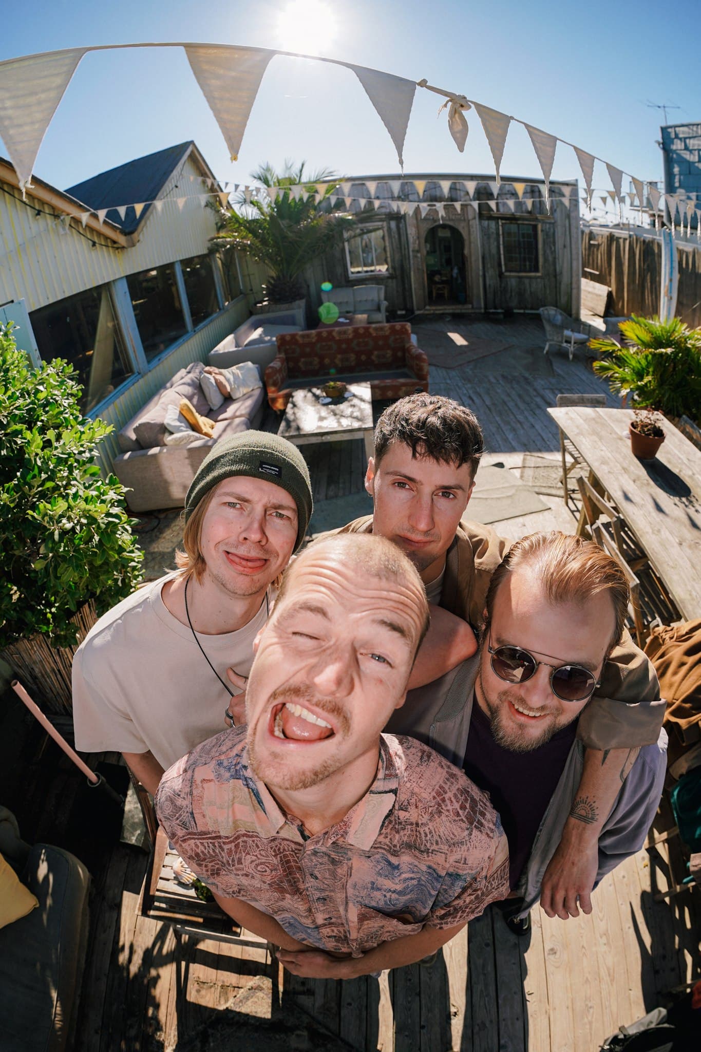 Wide-angle group portrait of Rum for Breakfast on a terrace, photographed from above.