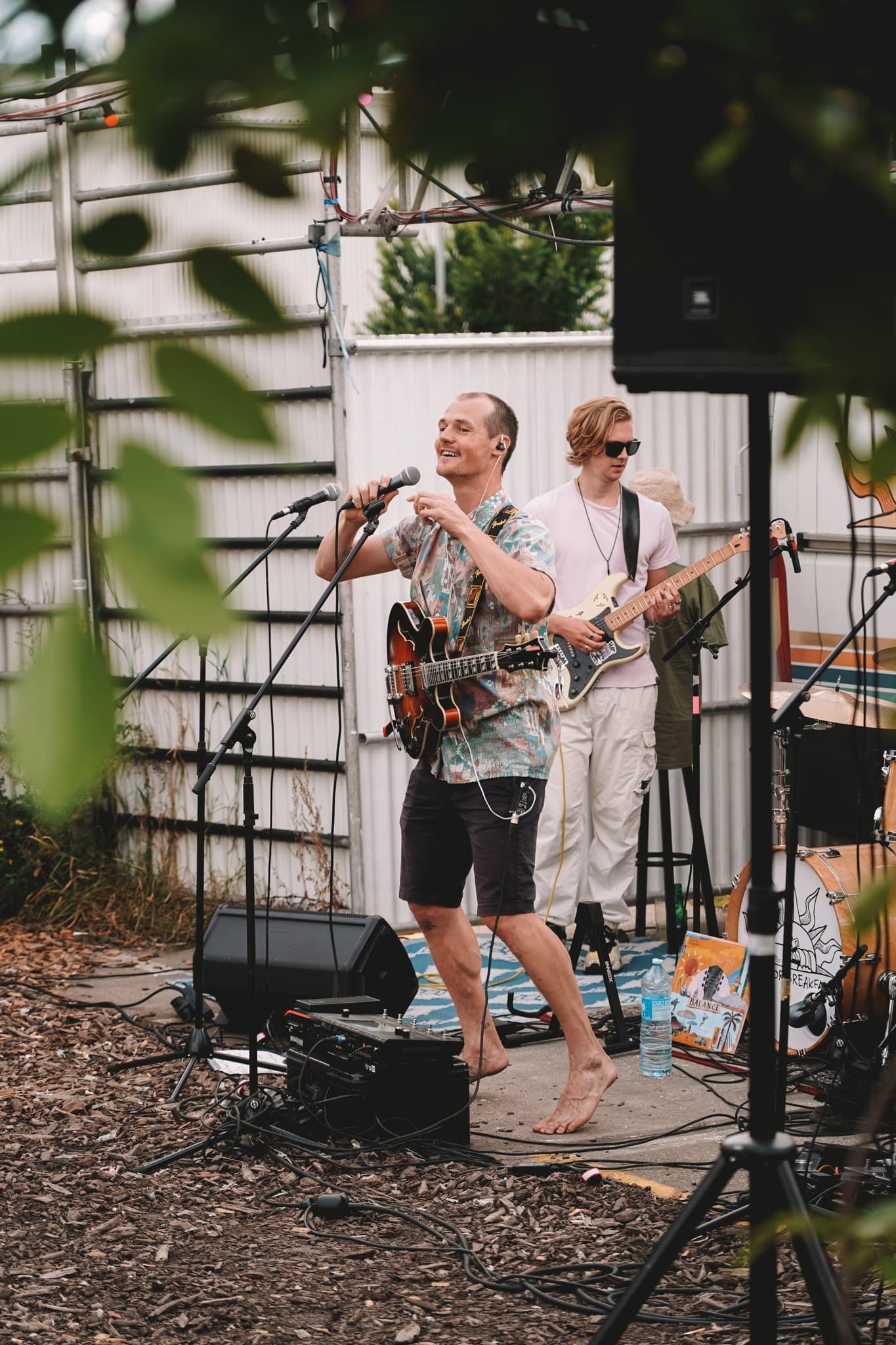 Musicians performing on an outdoor stage.