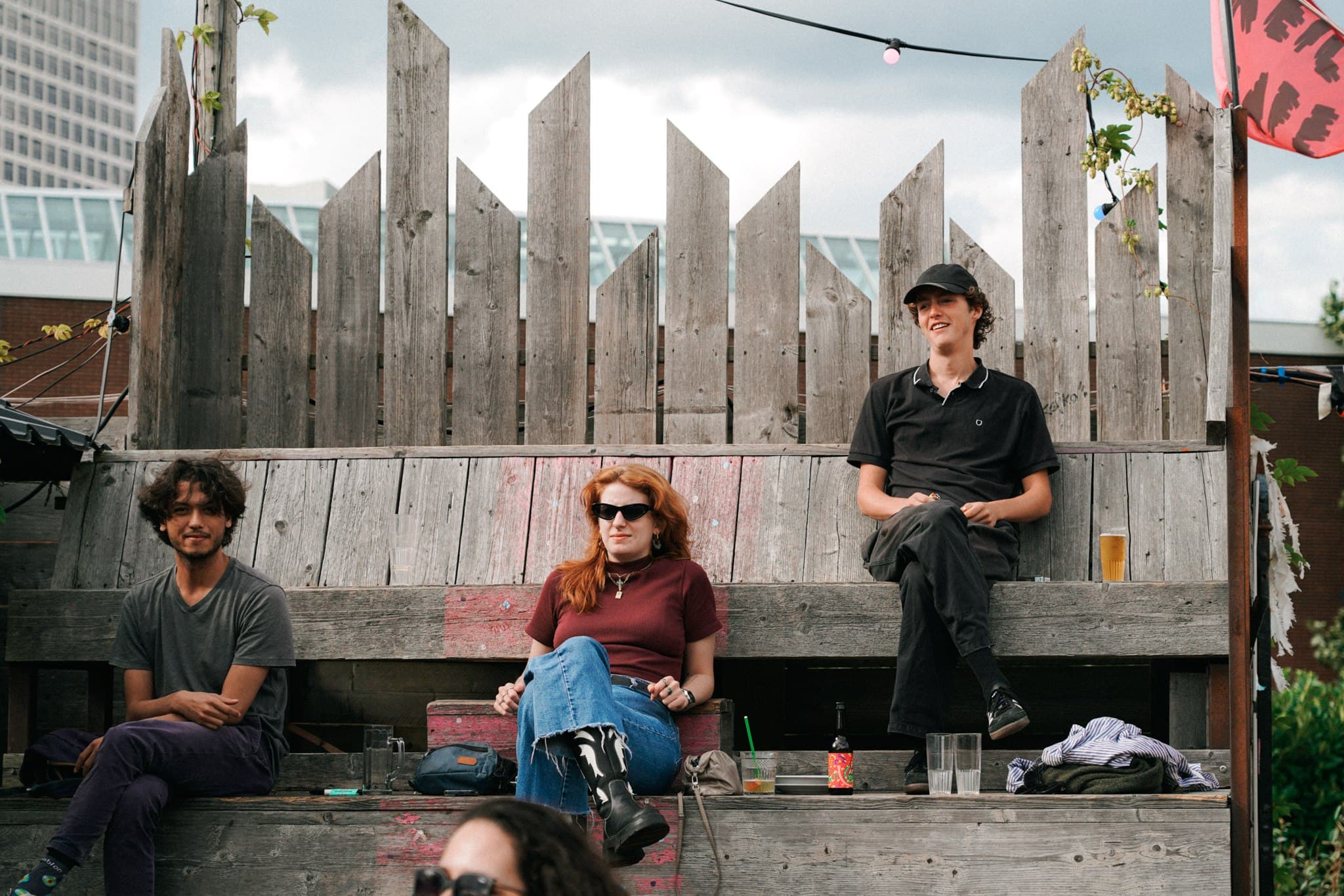Band members seated against a geometric concrete structure.