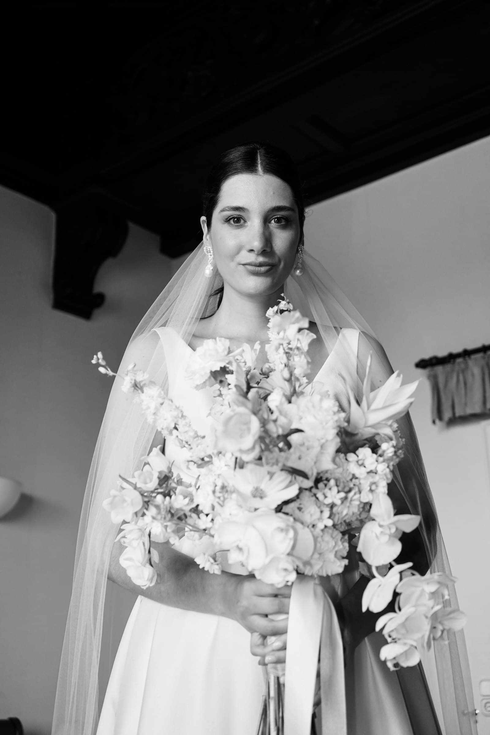 Black-and-white portrait of the bride holding a bouquet.